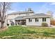 Well-maintained backyard with a lush green lawn, a covered patio, and an outdoor dining area at 5440 W Hinsdale Ave, Littleton, CO 80128