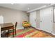 Finished basement area with wood floors, neutral paint, drop ceiling, and a desk and chair at 5440 W Hinsdale Ave, Littleton, CO 80128