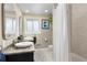Bright bathroom featuring a granite countertop, white vessel sinks, tile floors, and subway tile shower at 5440 W Hinsdale Ave, Littleton, CO 80128