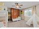 Bedroom with a whimsical teepee, neutral walls, and ceiling fan at 5440 W Hinsdale Ave, Littleton, CO 80128