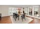 Dining room featuring a wooden table with black chairs and three large mirrors on the wall at 5440 W Hinsdale Ave, Littleton, CO 80128