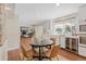 Dining area with a dark wooden table and an adjacent bar with wine cooler at 5440 W Hinsdale Ave, Littleton, CO 80128