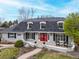 Beautiful home featuring an inviting front porch and well-manicured lawn at 5440 W Hinsdale Ave, Littleton, CO 80128
