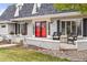 Inviting front porch with cozy seating and decorative flower pots that add to the curb appeal at 5440 W Hinsdale Ave, Littleton, CO 80128