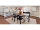 Bright kitchen with a butcher block island and stainless steel appliances, connecting to a dining area at 5440 W Hinsdale Ave, Littleton, CO 80128