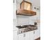 A stainless steel stove is featured in this kitchen with white subway tiles and custom vent hood at 5440 W Hinsdale Ave, Littleton, CO 80128