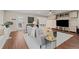 Bright living room with a stylish gray sofa, modern decor, and wood laminate flooring at 5440 W Hinsdale Ave, Littleton, CO 80128