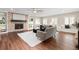 Spacious living room with a brick fireplace, built-in shelves, and a neutral-colored sofa at 5440 W Hinsdale Ave, Littleton, CO 80128