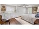 Spacious main bedroom showcasing custom built-ins, a plush rug, and ceiling fan at 5440 W Hinsdale Ave, Littleton, CO 80128