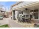 Covered patio area with an outdoor dining table, a ceiling fan, and curtains at 5440 W Hinsdale Ave, Littleton, CO 80128