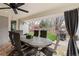 Covered patio area with an outdoor dining table and a grill at 5440 W Hinsdale Ave, Littleton, CO 80128