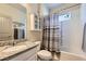 Clean bathroom with shower/tub combo, cabinet, and granite countertop at 6863 E 132Nd Pl, Thornton, CO 80602