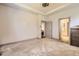 Spacious bedroom with carpet, neutral walls, and easy access to the ensuite bathroom at 6863 E 132Nd Pl, Thornton, CO 80602