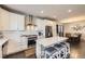 Bright, modern kitchen with a large island, white cabinets, and stainless steel appliances at 6863 E 132Nd Pl, Thornton, CO 80602