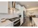 Modern kitchen boasts stainless steel appliances, white cabinetry, and a stylish backsplash at 6863 E 132Nd Pl, Thornton, CO 80602