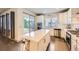 Modern kitchen with an island, stainless steel appliances, and access to an outdoor patio at 6863 E 132Nd Pl, Thornton, CO 80602