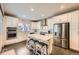 Contemporary kitchen with stainless steel appliances, a center island, and white cabinetry at 6863 E 132Nd Pl, Thornton, CO 80602
