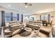 Open-concept living room featuring neutral tones, ample seating, and abundant natural light at 6863 E 132Nd Pl, Thornton, CO 80602