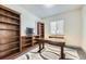 Home office with custom built-ins, a modern desk, and a bright, airy feel at 6863 E 132Nd Pl, Thornton, CO 80602