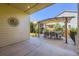 Covered patio with outdoor dining area and a view of the lush backyard at 6863 E 132Nd Pl, Thornton, CO 80602
