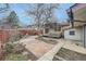 Charming backyard featuring a brick patio, wooden deck, and a beautiful bare tree focal point at 4257 Graham Ct, Boulder, CO 80305