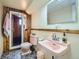 Retro bathroom featuring pink fixtures and wood paneled shower at 4257 Graham Ct, Boulder, CO 80305