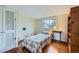 Well-lit bedroom with hardwood floors, a window, and traditional décor at 4257 Graham Ct, Boulder, CO 80305