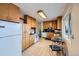 Functional kitchen with ample cabinet space, white appliances, and a cozy dining area at 4257 Graham Ct, Boulder, CO 80305