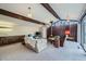 Spacious living room with wood beams, fireplace, and a large picture window at 4257 Graham Ct, Boulder, CO 80305