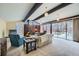 Bright living room features exposed beams, fireplace, and large windows at 4257 Graham Ct, Boulder, CO 80305