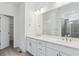 Bathroom featuring dual sinks, quartz countertops, and sleek, modern fixtures at 8229 Butte Creek St, Littleton, CO 80125