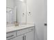 Bathroom vanity featuring a large mirror, quartz countertops, and sleek fixtures at 8229 Butte Creek St, Littleton, CO 80125