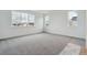 Bright, spacious bedroom with plush carpeting and multiple windows offering natural light at 8229 Butte Creek St, Littleton, CO 80125
