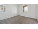 This bedroom has neutral carpet and two sunny windows at 8229 Butte Creek St, Littleton, CO 80125