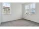 Spacious bedroom with neutral carpeting and large windows, offering plenty of natural light at 8229 Butte Creek St, Littleton, CO 80125