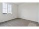 Cozy bedroom with plush carpeting and a large window providing natural light at 8229 Butte Creek St, Littleton, CO 80125