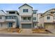 New construction home showing a modern elevation, blue door and landscaping at 8229 Butte Creek St, Littleton, CO 80125