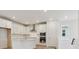 Modern, all white kitchen features stainless steel appliances and plenty of counter space at 8229 Butte Creek St, Littleton, CO 80125