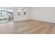Open living space with hardwood floors and a glass door leading to the balcony at 8229 Butte Creek St, Littleton, CO 80125