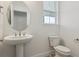 Neutral powder room with a pedestal sink at 8229 Butte Creek St, Littleton, CO 80125
