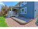 Backyard featuring a covered patio, sliding glass door, and concrete slab at 2474 Ravenswood Ct, Longmont, CO 80504