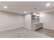 A bar area featuring gray cabinets, decorative backsplash tile, sink, faucet, and floating shelves at 2474 Ravenswood Ct, Longmont, CO 80504