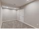 An empty room in the finished basement featuring gray walls and carpet flooring at 2474 Ravenswood Ct, Longmont, CO 80504