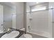 Bright bathroom with a single sink, tile surround shower over tub, and window for natural light at 2474 Ravenswood Ct, Longmont, CO 80504