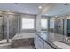 Bright bathroom with double sinks, walk in shower, tub, and large vanity mirror at 2474 Ravenswood Ct, Longmont, CO 80504