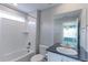 This bathroom features a tiled shower over tub, vanity sink, large mirror and good lighting at 2474 Ravenswood Ct, Longmont, CO 80504
