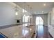 Open kitchen with large island, granite countertop and stainless steel appliances with an adjoining living room at 2474 Ravenswood Ct, Longmont, CO 80504