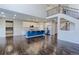 Open kitchen with modern appliances, a blue island with granite countertops, and dark wooden floors at 2474 Ravenswood Ct, Longmont, CO 80504