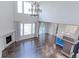 Spacious living room with hardwood floors, fireplace, large windows, and sliding door to the outside at 2474 Ravenswood Ct, Longmont, CO 80504