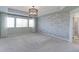 Large main bedroom with stone accent wall, plush carpet, and modern lighting at 2474 Ravenswood Ct, Longmont, CO 80504